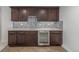 Wet bar featuring wood cabinets and stainless-steel beverage cooler at 3322 W 26Th Ave, Denver, CO 80211