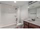 Neat bathroom with shower and tub combo featuring white tiled walls, vanity with dark cabinets and quarts countertop at 3322 W 26Th Ave, Denver, CO 80211
