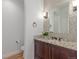 Powder room featuring mosaic tile wall, granite countertop, and wooden vanity at 3322 W 26Th Ave, Denver, CO 80211
