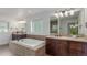 Bright bathroom showcasing a soaking tub with tile surround, and dual sink vanities with granite countertops at 3322 W 26Th Ave, Denver, CO 80211