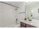 Bright bathroom featuring a tub with tile surround and a modern vanity at 3322 W 26Th Ave, Denver, CO 80211