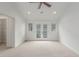 Bright bedroom featuring ceiling fan and double doors to the exterior at 3322 W 26Th Ave, Denver, CO 80211