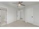 Bright bedroom displays an ensuite bathroom and closet, with carpet flooring beneath a ceiling fan at 3322 W 26Th Ave, Denver, CO 80211