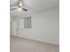 Empty bedroom showing neutral walls and carpet, a fan, and a window providing natural light at 3322 W 26Th Ave, Denver, CO 80211