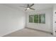 Simple bedroom shows a window with tree view, and carpet flooring beneath a ceiling fan at 3322 W 26Th Ave, Denver, CO 80211