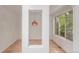 Bright entryway with hardwood floors, a unique pendant light, and large windows overlooking the lush greenery at 3322 W 26Th Ave, Denver, CO 80211