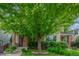 Charming brick home with lush landscaping and a mature tree providing shade and curb appeal at 3322 W 26Th Ave, Denver, CO 80211