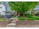 Charming home featuring a landscaped front yard with stone accents and a mature tree for added curb appeal at 3322 W 26Th Ave, Denver, CO 80211