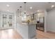 Modern kitchen with stainless steel appliances, stylish lighting, and a large island perfect for cooking and gathering at 3322 W 26Th Ave, Denver, CO 80211