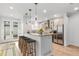 Modern kitchen with granite countertops, stainless steel appliances, and an eat-in island with barstool seating at 3322 W 26Th Ave, Denver, CO 80211