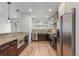 Beautiful kitchen featuring stainless steel appliances, granite countertops, and a stylish backsplash at 3322 W 26Th Ave, Denver, CO 80211