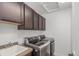 Functional laundry room featuring front load washer and dryer, sink, and ample storage cabinets at 3322 W 26Th Ave, Denver, CO 80211