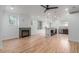 Spacious living room features hardwood floors, a modern fireplace, and seamless flow into an open kitchen area at 3322 W 26Th Ave, Denver, CO 80211