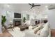 Bright living room featuring a fireplace, hardwood floors, and an open layout connecting to the kitchen at 3322 W 26Th Ave, Denver, CO 80211