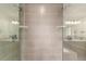 Stylish glass-enclosed shower with tiled walls and ceiling-mounted shower head; reflective glass creates dual image at 3322 W 26Th Ave, Denver, CO 80211