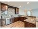 Modern bar area featuring wooden cabinets, granite countertops, and stainless steel appliances including a wine fridge at 770 International Isle Dr, Castle Rock, CO 80108