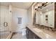 Elegant bathroom featuring a glass enclosed shower, large vanity, and detailed tile work at 770 International Isle Dr, Castle Rock, CO 80108
