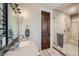 Modern bathroom featuring glass shower, neutral toned stone, and decorative vanity at 770 International Isle Dr, Castle Rock, CO 80108
