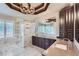 Elegant bathroom features dual sinks, marble countertops, soaking tub, and glass shower at 770 International Isle Dr, Castle Rock, CO 80108