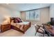 Cozy bedroom with natural light, wooden bed frame, and window with white shutters at 770 International Isle Dr, Castle Rock, CO 80108