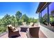 Outdoor deck with beautiful views and four comfortable lounge chairs, perfect for entertaining at 770 International Isle Dr, Castle Rock, CO 80108