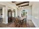 Elegant dining room featuring a wood ceiling, large windows, and classic furniture, perfect for entertaining at 770 International Isle Dr, Castle Rock, CO 80108