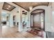 Grand foyer with a brick vaulted ceiling, hardwood floors, and an elegant wooden front door with glass sidelights at 770 International Isle Dr, Castle Rock, CO 80108