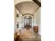 Grand foyer with a high brick ceiling, hardwood floors, columns, and an elegant chandelier at 770 International Isle Dr, Castle Rock, CO 80108