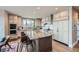 Gourmet kitchen featuring custom cabinets, an oversized island with seating, and high-end stainless steel appliances at 770 International Isle Dr, Castle Rock, CO 80108