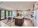 Bright, open kitchen with an island, granite countertops, custom cabinets, and access to an outdoor deck at 770 International Isle Dr, Castle Rock, CO 80108