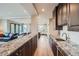 Stylish kitchen with dark wood cabinetry, granite countertops, stainless steel appliances, and an open concept design at 770 International Isle Dr, Castle Rock, CO 80108