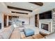 Spacious living room features stone fireplace, wet bar, and beamed ceilings at 770 International Isle Dr, Castle Rock, CO 80108