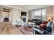 Bright living room with hardwood floors, a fireplace, and a large picture window offering stunning views at 770 International Isle Dr, Castle Rock, CO 80108