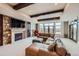Cozy living room with beamed ceilings, fireplace, and scenic views at 770 International Isle Dr, Castle Rock, CO 80108
