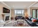 Inviting living room with a fireplace, large windows offering scenic views, and comfortable seating at 770 International Isle Dr, Castle Rock, CO 80108