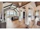 Open-concept living room with soaring ceilings, exposed beams, and large windows with a scenic view at 770 International Isle Dr, Castle Rock, CO 80108