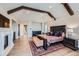 Comfortable main bedroom with beamed ceilings, fireplace, and access to outdoor deck at 770 International Isle Dr, Castle Rock, CO 80108