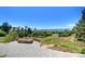 Stone patio with outdoor fireplace and views of the sprawling property at 770 International Isle Dr, Castle Rock, CO 80108