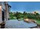 Outdoor patio area with a stone fire pit and views of the surrounding landscape at dusk at 770 International Isle Dr, Castle Rock, CO 80108