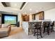 Recreation room featuring a stone bar, comfortable seating, and a golf simulator screen at 770 International Isle Dr, Castle Rock, CO 80108