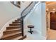 Elegant curved staircase with wood treads, iron railing and custom lighting at 770 International Isle Dr, Castle Rock, CO 80108