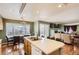 Bright, open kitchen featuring an island with a double sink and a view into the living and dining areas at 9606 Adelaide Cir, Highlands Ranch, CO 80130