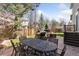 Entertainer's backyard with a fire pit, patio dining, grill, and privacy fence at 4094 Bimini Ct, Boulder, CO 80301