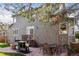 Landscaped backyard featuring mature trees, a fire pit, grill and outdoor dining at 4094 Bimini Ct, Boulder, CO 80301