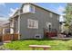 Backyard with lush lawn, fire pit, patio area, wooden fence and mature trees at 4094 Bimini Ct, Boulder, CO 80301