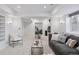 Spacious basement with cozy sectional and entertainment area featuring a modern chair, lighting, and stylish accents at 4094 Bimini Ct, Boulder, CO 80301