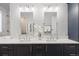 Modern bathroom featuring a double vanity with elegant countertops and contemporary fixtures under bright lighting at 4094 Bimini Ct, Boulder, CO 80301