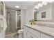 Well-lit bathroom featuring a glass enclosed shower and granite countertop vanity at 4094 Bimini Ct, Boulder, CO 80301
