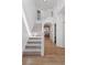 Bright entryway with hardwood floors, a staircase with white railings, and soaring ceilings at 4094 Bimini Ct, Boulder, CO 80301