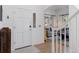 Welcoming foyer with a glass-panel front door, hardwood floors, and a view into the living room at 4094 Bimini Ct, Boulder, CO 80301